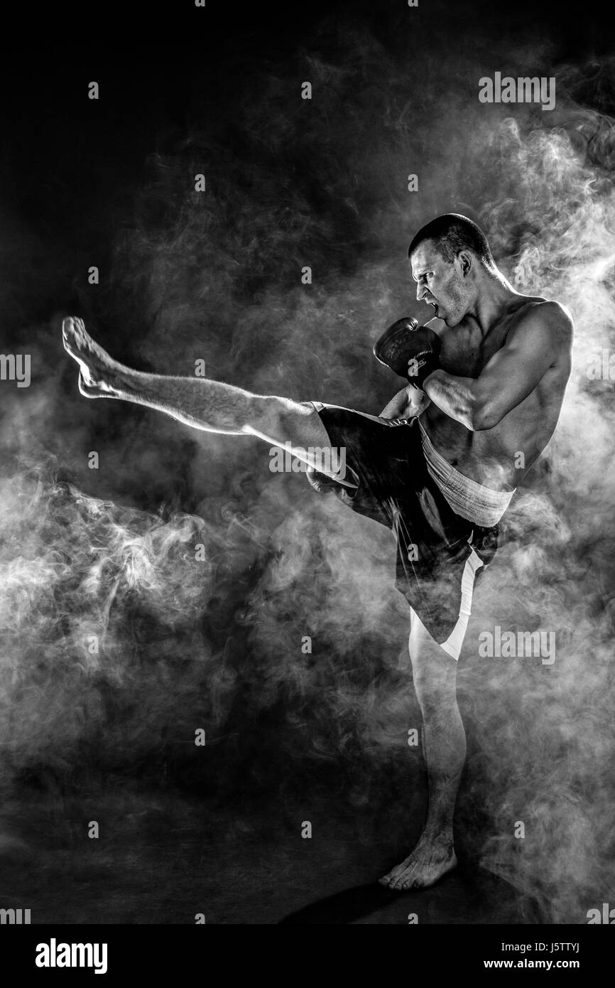 Happy Winning Mixed Martial Arts Fighter Punching in Smoke Stock Photo