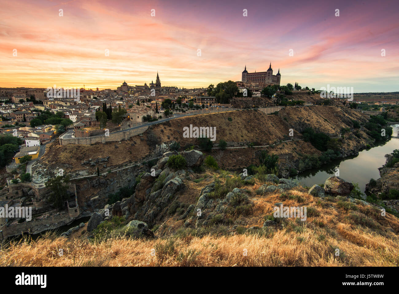 Colorful sunset over beautiful city of Toledo,Spain and river Tagus Stock Photo