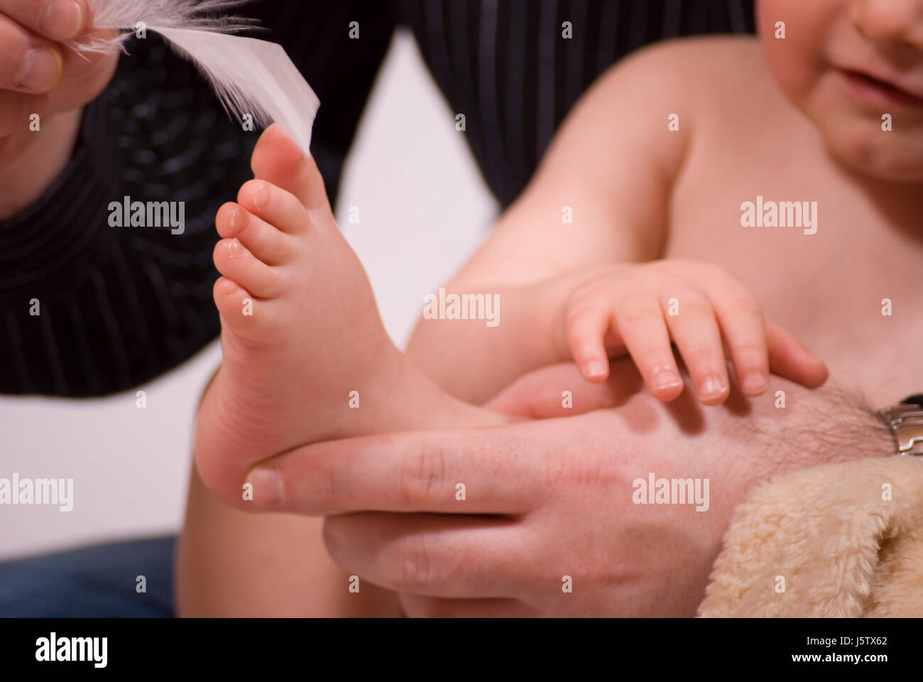 baby feet tickle penholders fountain-pen filler child hand hands lie lying lies Stock Photo