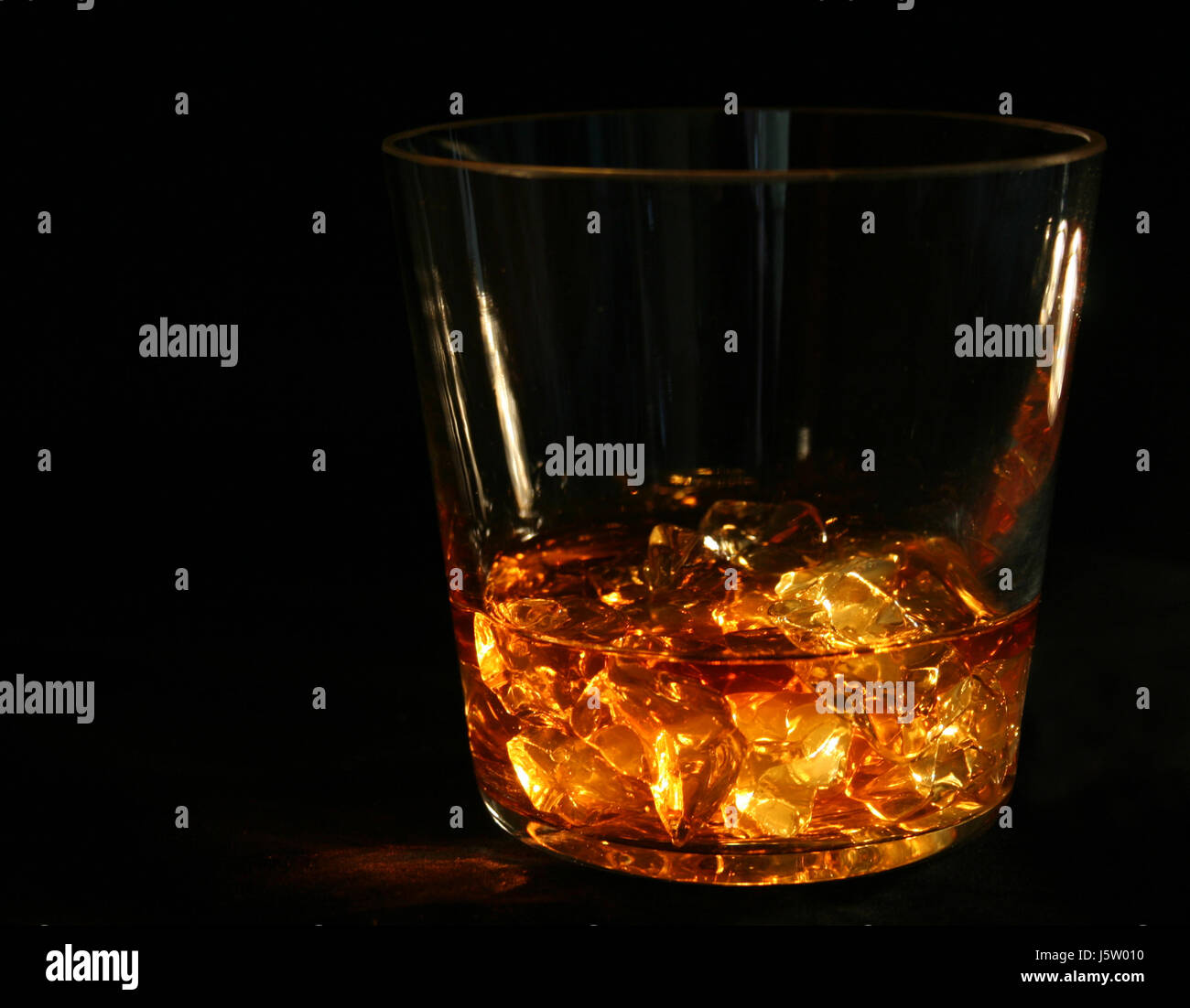 glass chalice tumbler ice cube whiskey still life glass chalice tumbler drink Stock Photo
