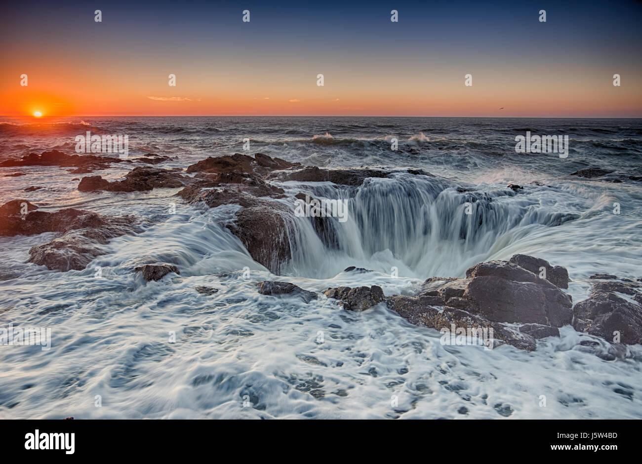 Thor's Well, in Yachats Oregon.  Gateway to the Underworld.  A massive undersea cave whose roof collapsed a very long time ago. Stock Photo