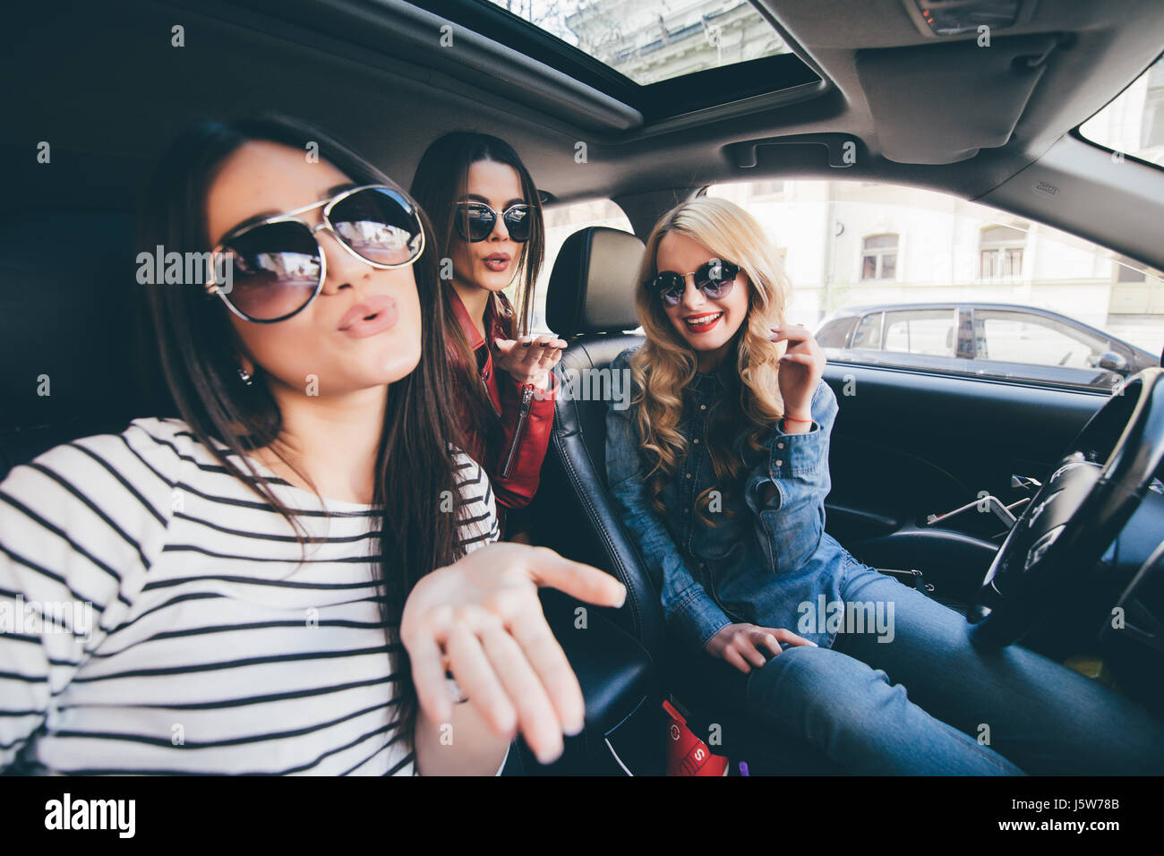 Group Of Girls Having Fun In The Car And Taking Selfies With Camera 
