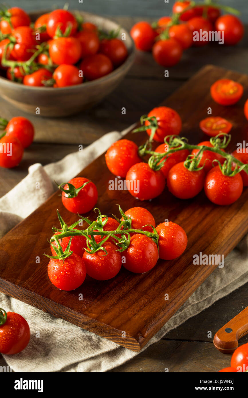 Raw Organic Red Cherry Tomatoes on the Vine Stock Photo - Alamy