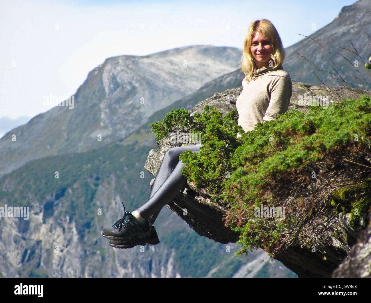 Girl sitting on edge cliff hi-res stock photography and images - Alamy