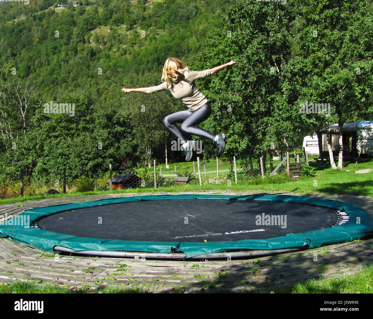 Girl jumping on a trampoline Stock Photo
