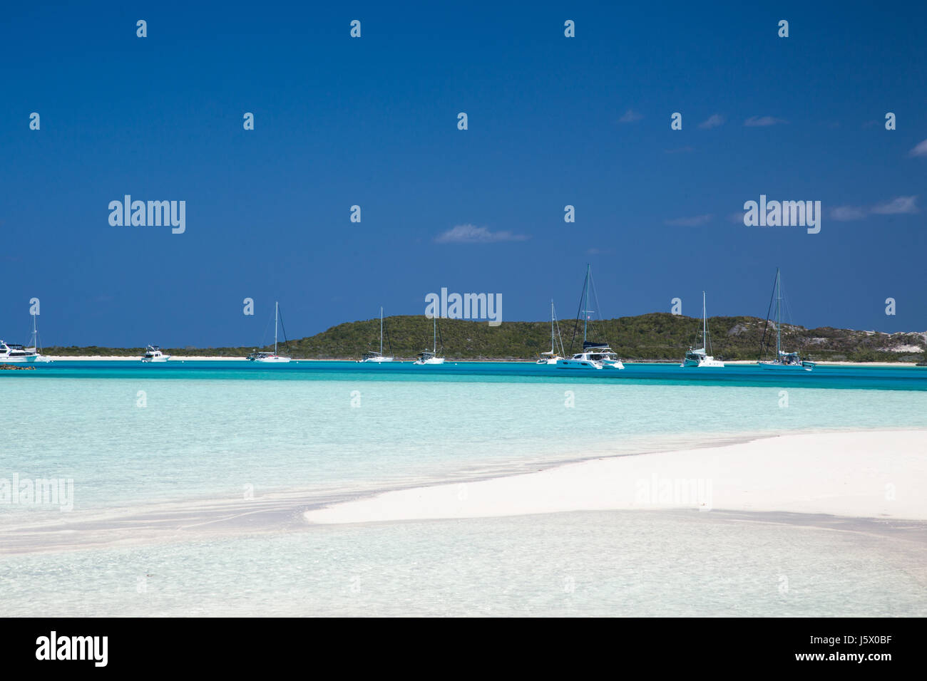 A busy Exuma Bahamas anchorage with sailboats and sandbars Stock Photo