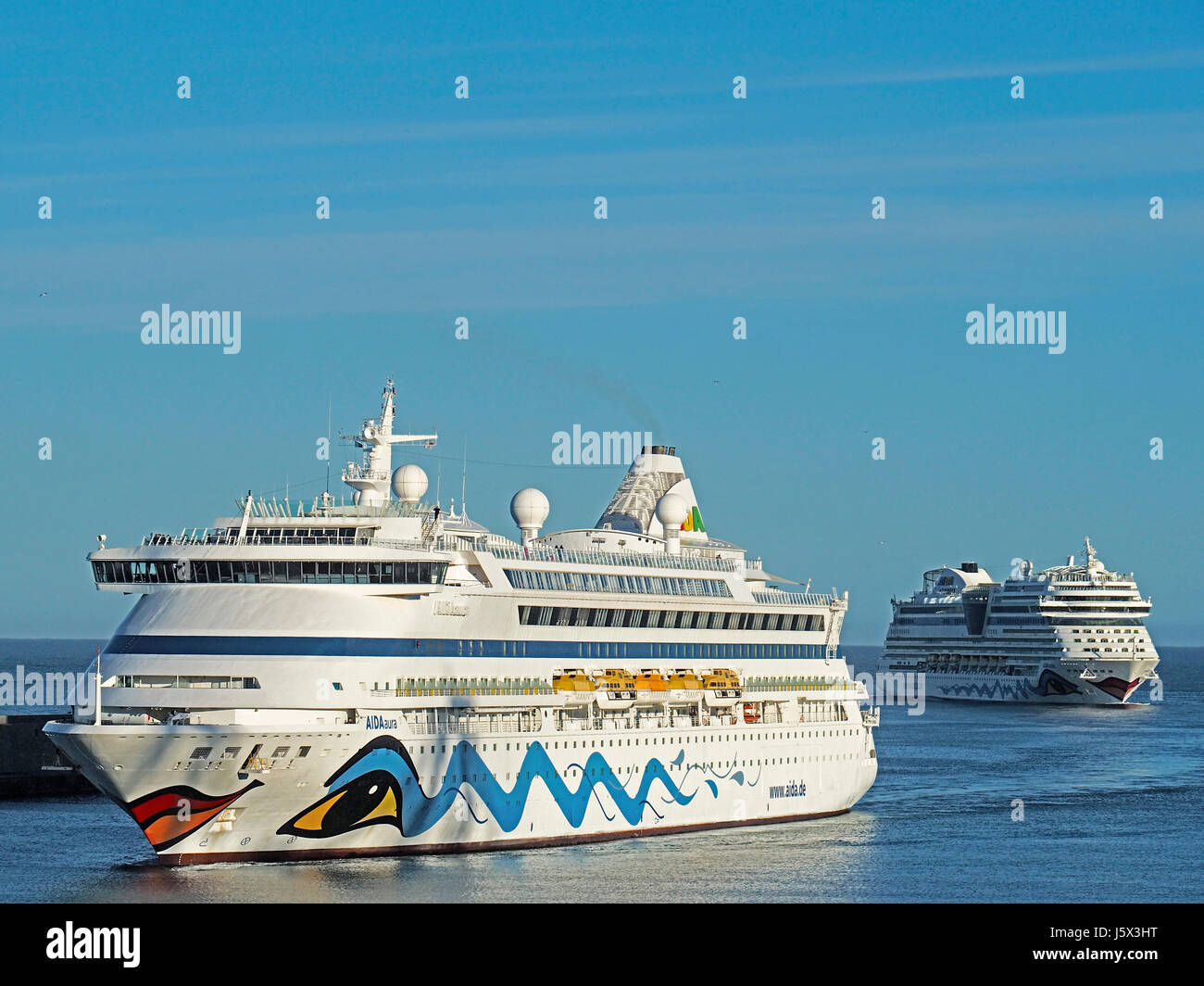 Cruise ships of the AIDA line, Aura and Stella, entering harbor of Civitaveccia, port for Rome. Stock Photo