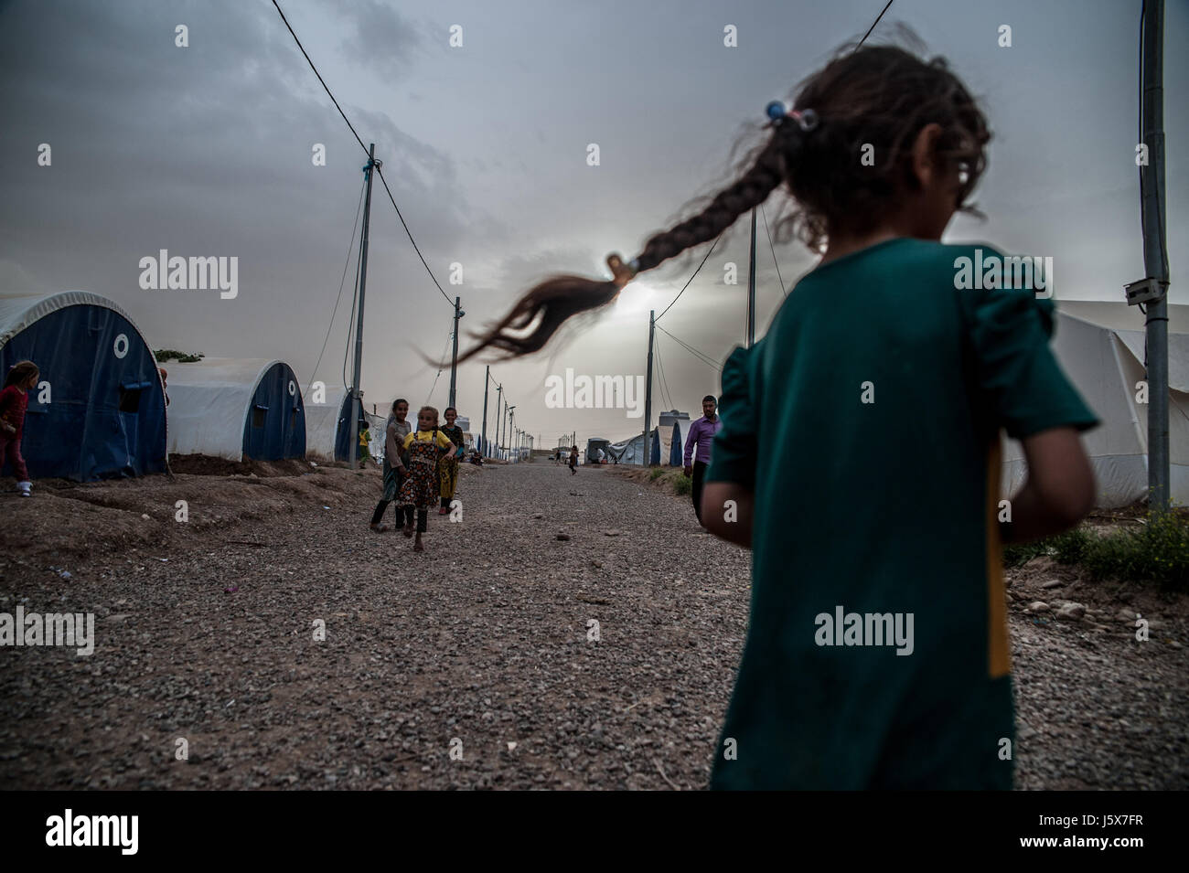 Children displaced by fighting in Mosul play in Khazir IDP camp in Kurdistan, Iraq. Stock Photo