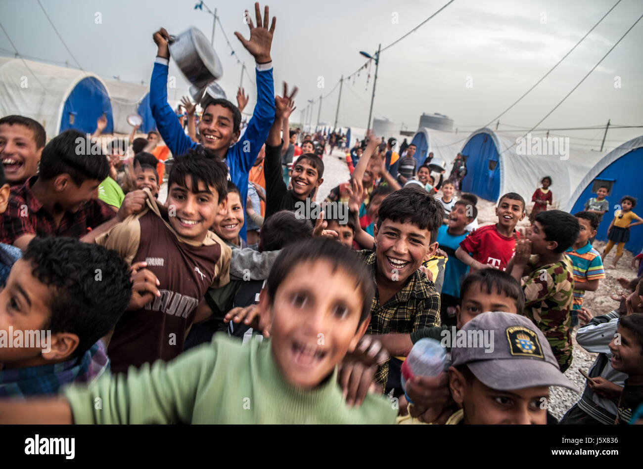 Children displaced by fighting in Mosul play in Khazir IDP camp in Kurdistan, Iraq. Stock Photo