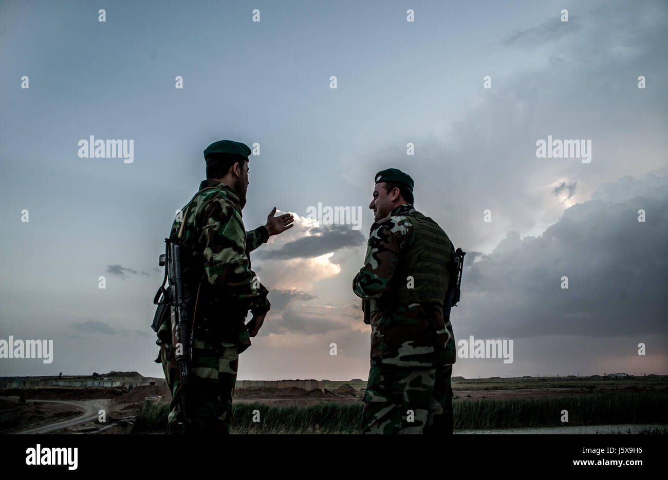 Kurdish Peshmerga forces stand guard at a checkpoint near the frontline in Hawija, Iraq. Stock Photo