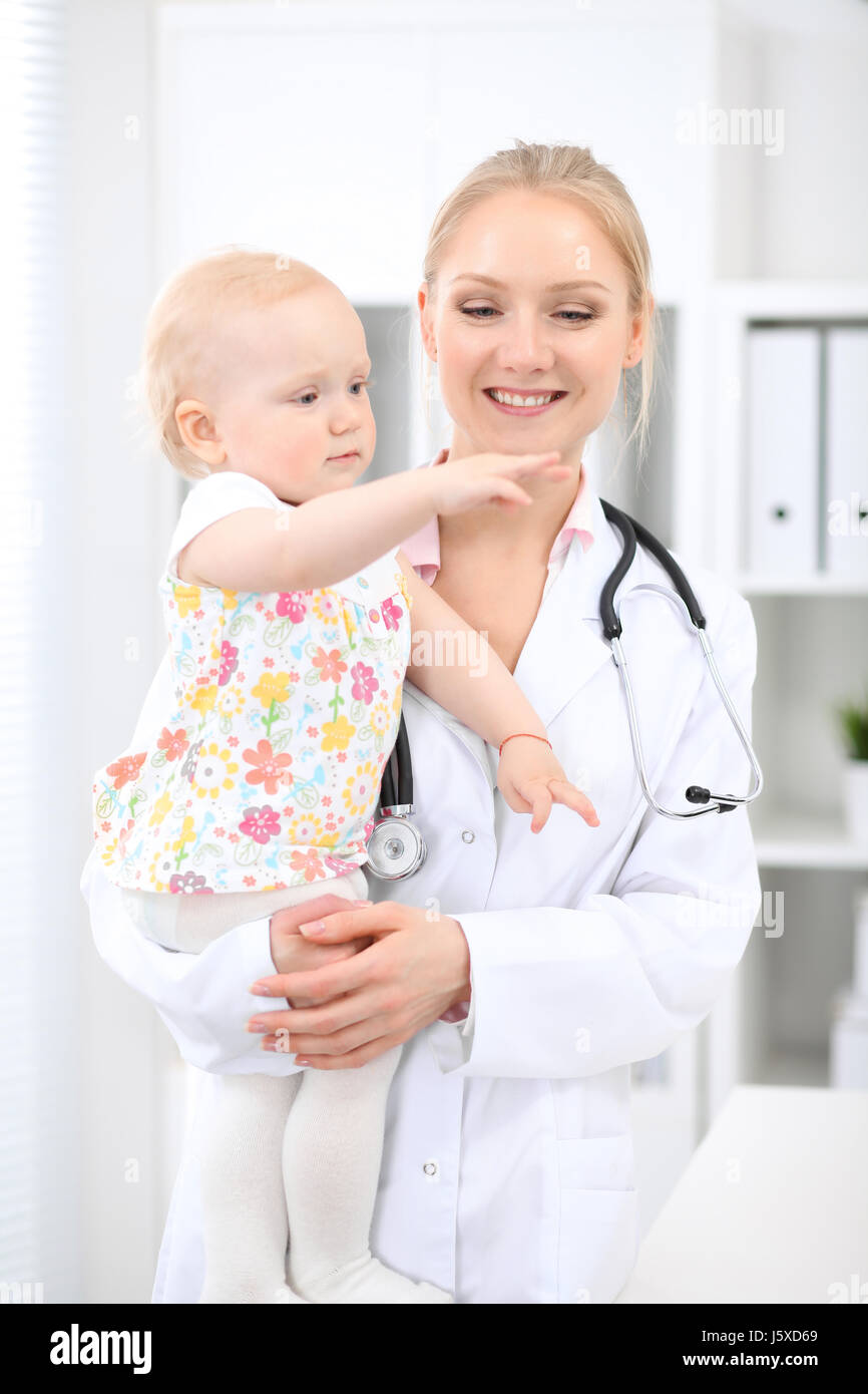 Pediatrician is taking care of baby in hospital. Little girl is being