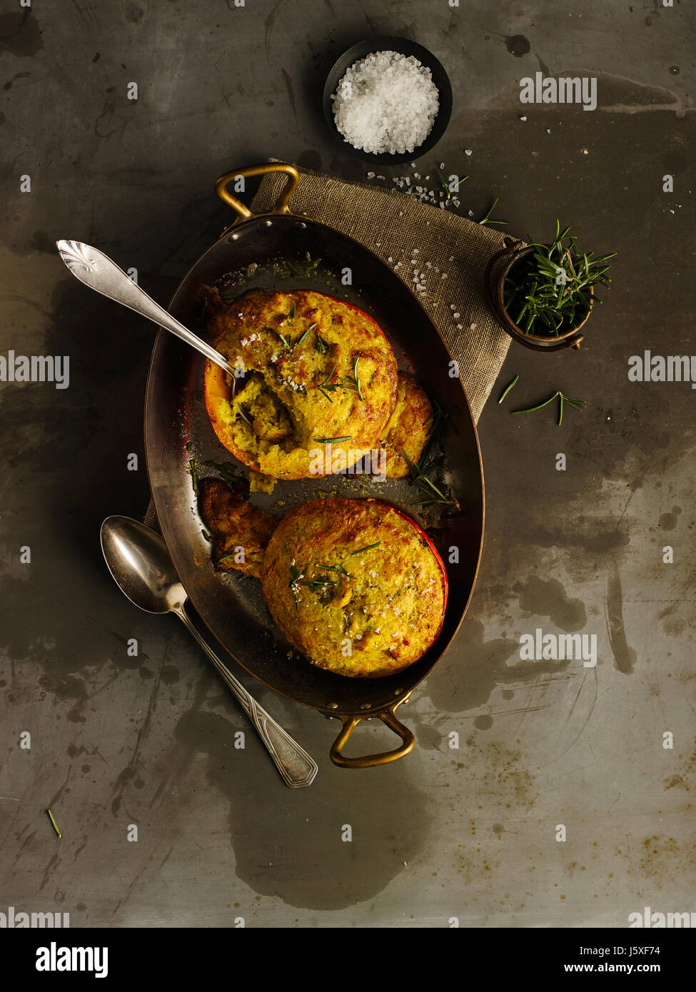Filled pumpkin with parmesan and herbs Stock Photo
