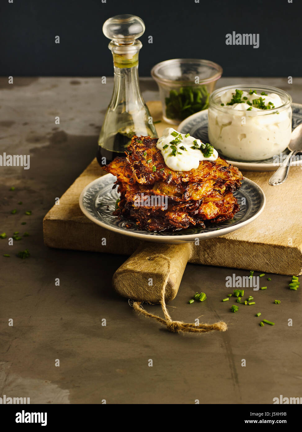 Hash browned potatoes with pumpkin and chives curd Stock Photo