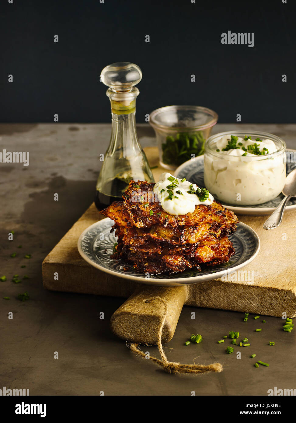Hash browned potatoes with pumpkin and chives curd Stock Photo