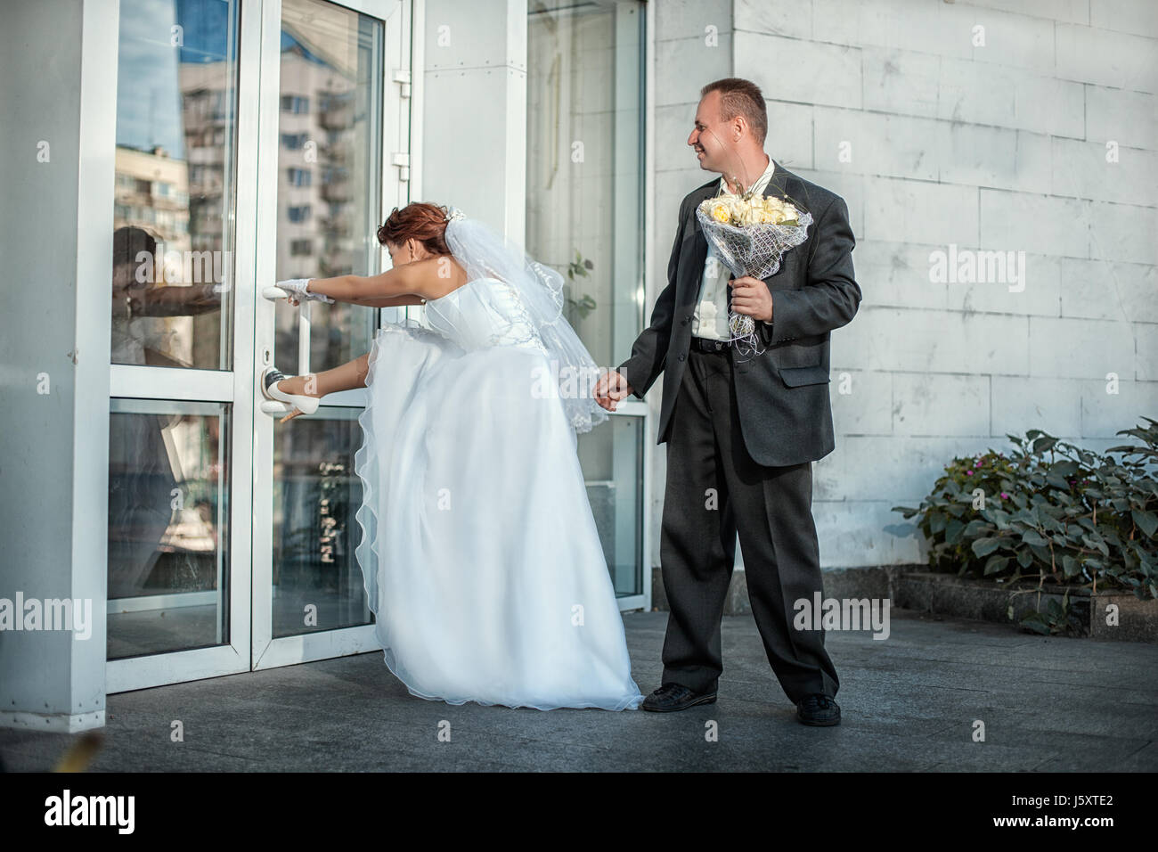 The bride and groom came to the wedding and want to go. Stock Photo