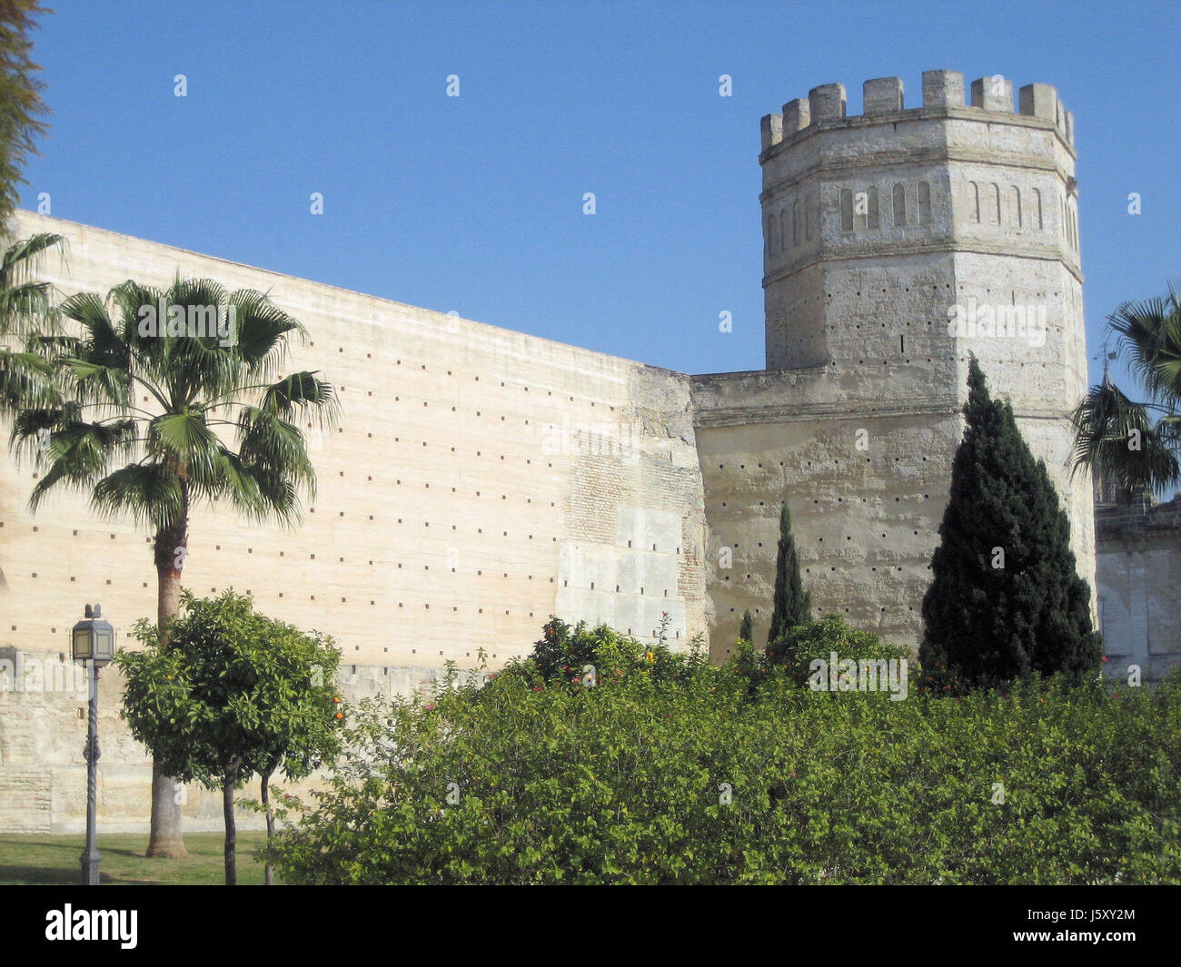historical spain andalusia tower historical spain wall palm tree pinnacle Stock Photo