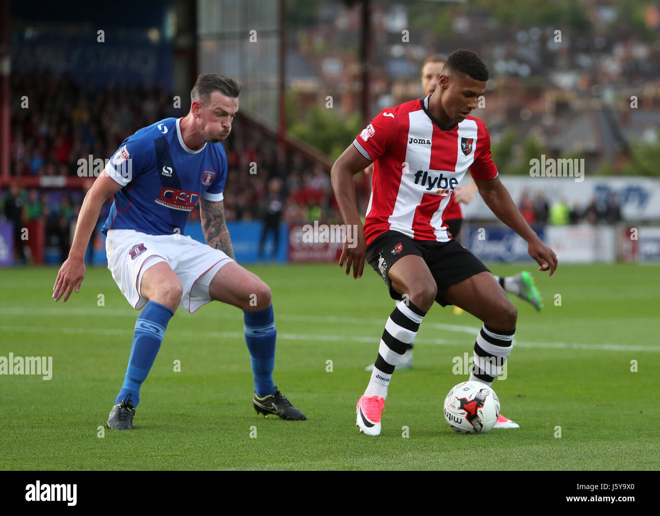 Mike Raynes Exeter City's Ollie Watkins and Carlisle United's Michael Raynes (left ...