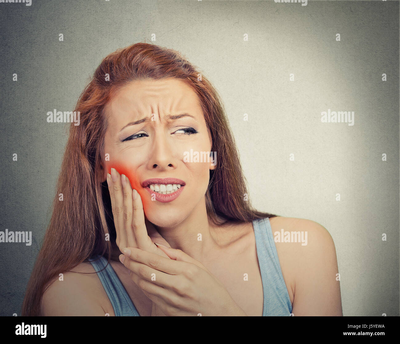 Closeup portrait young woman with sensitive tooth ache crown problem