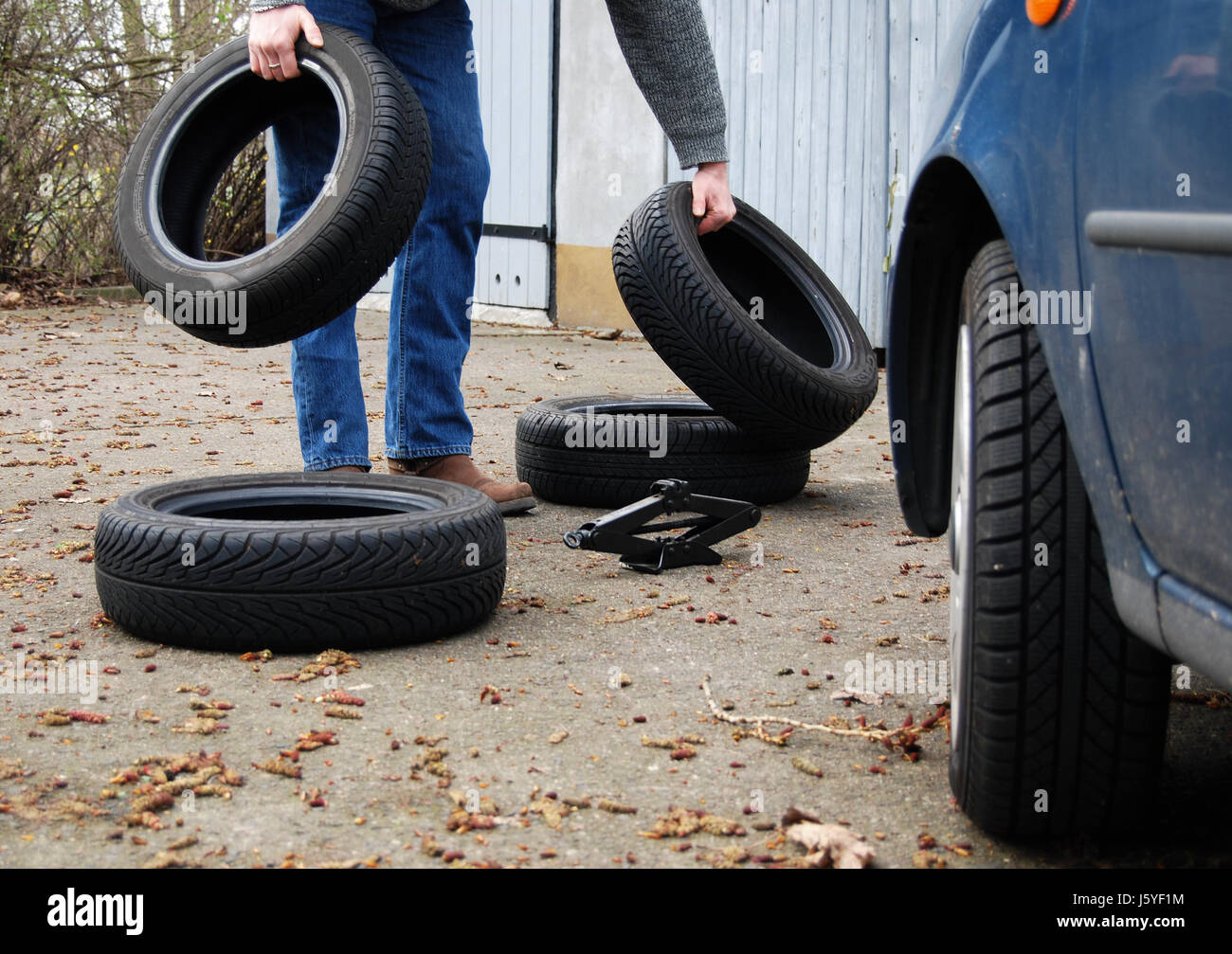 grasp snow tyre layman change of tyres change of a wheel tyre tire tyres man Stock Photo