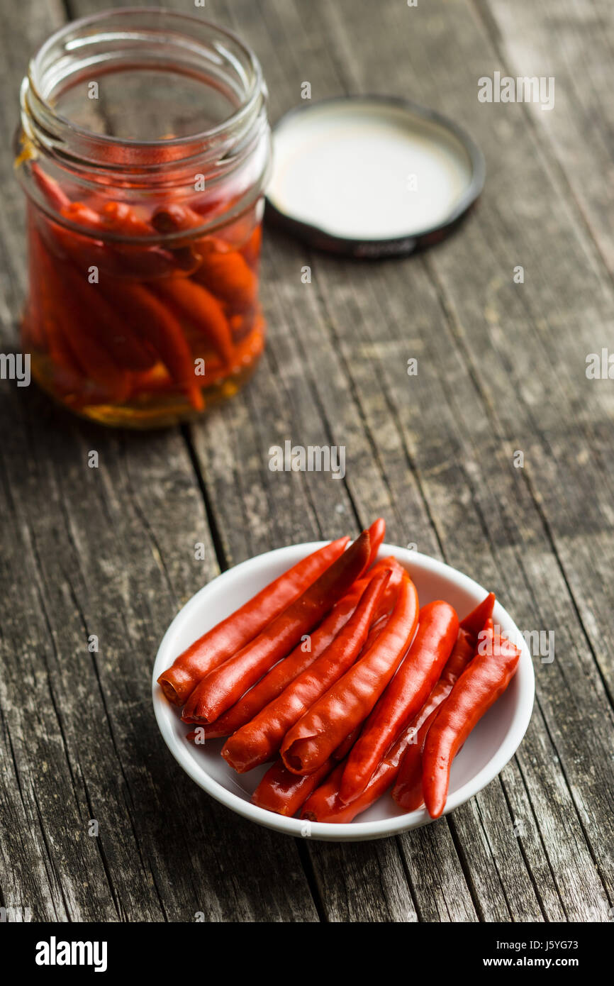 Pickled chili peppers on white bowl Stock Photo Alamy
