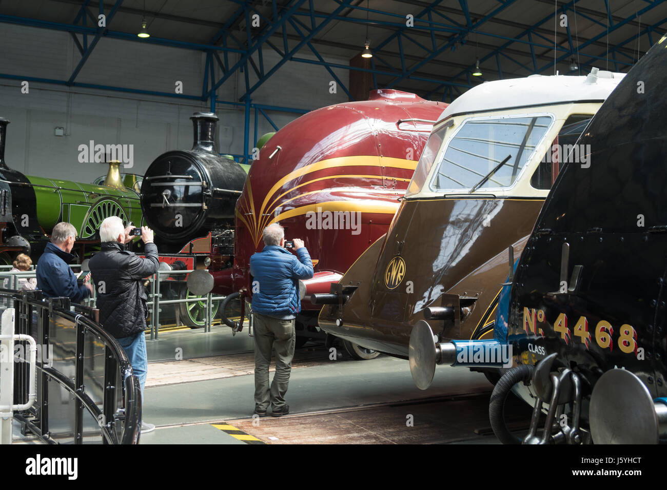 Men photographing streamlined train in  the National Railway Museum York, England, UK Stock Photo