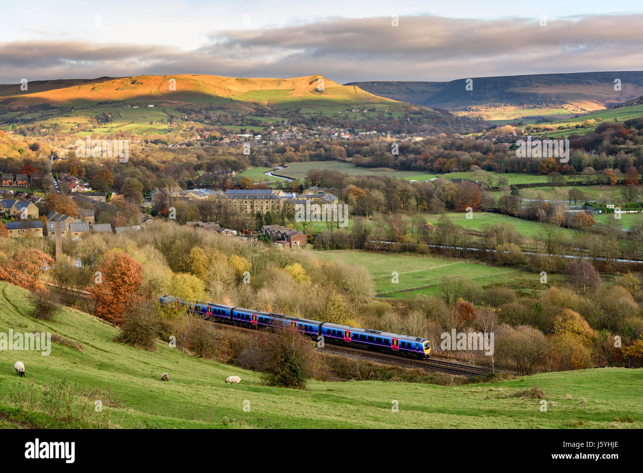 Passanger train passing through british countryside near greater Manchester, England. Stock Photo