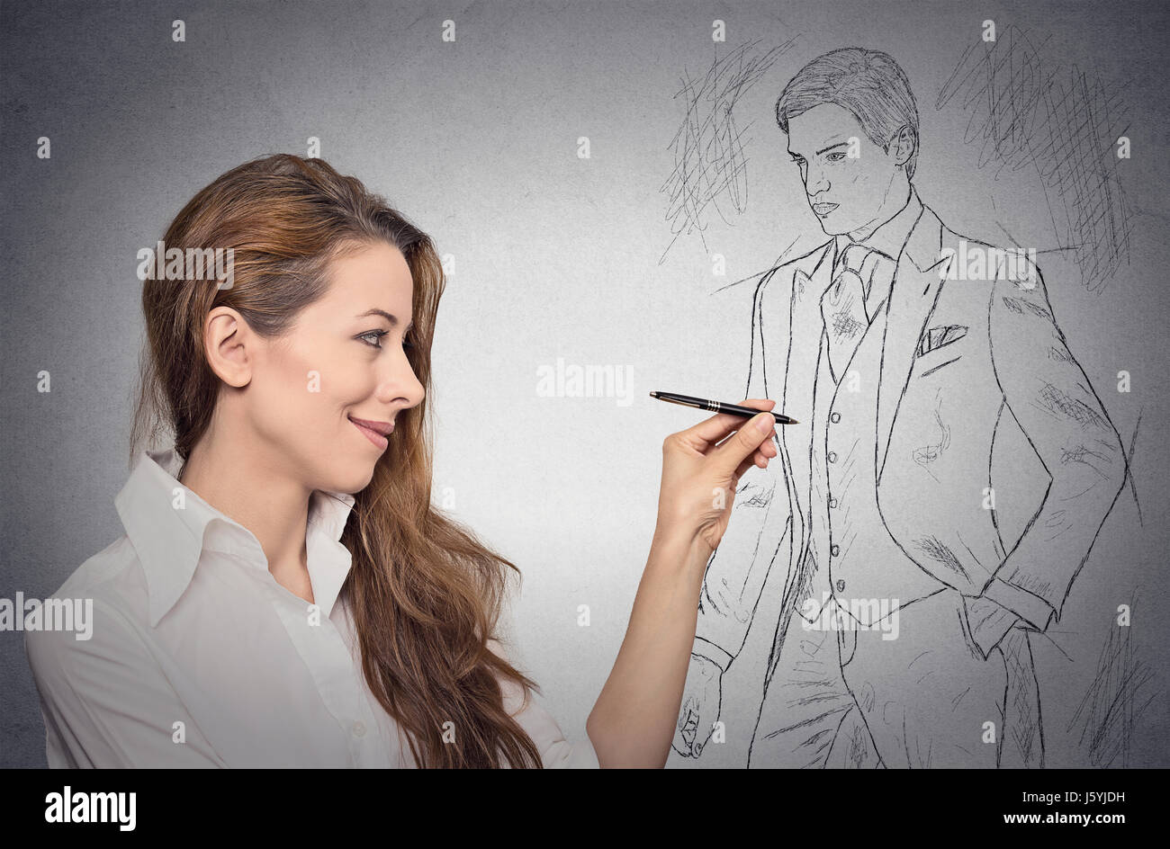 woman stylist drawing sketch of male model dressed in suit Stock Photo