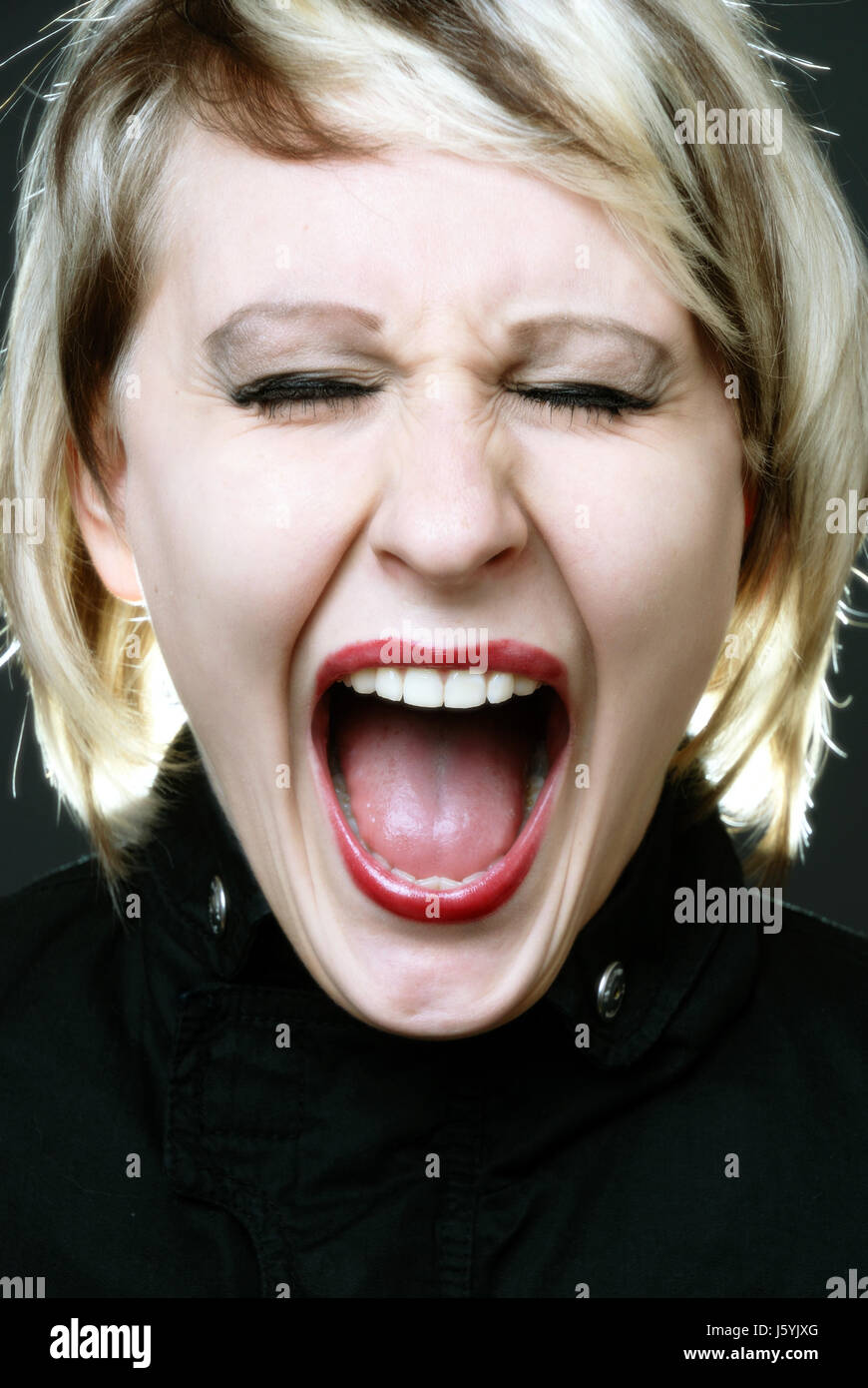 woman sour rage roar moo raving furious angry irately unlocking shouting shout Stock Photo