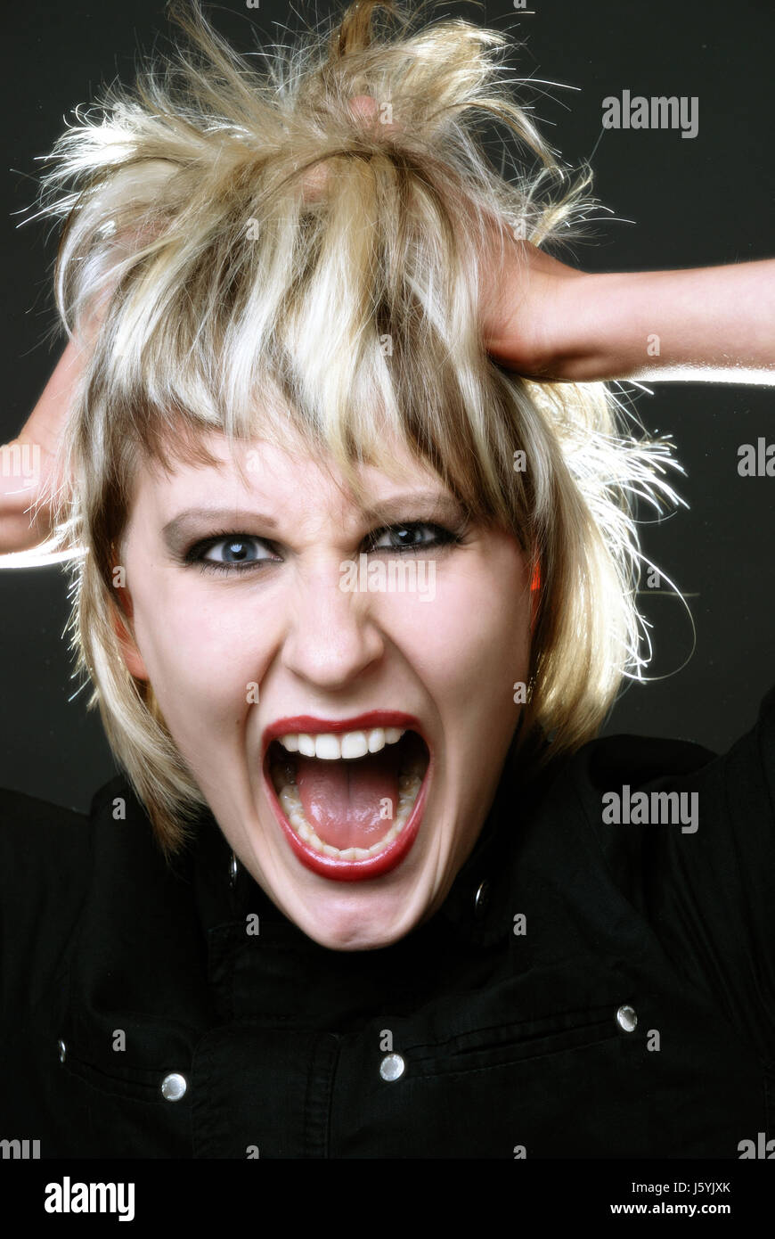 woman sour rage roar moo raving furious angry irately unlocking shouting shout Stock Photo