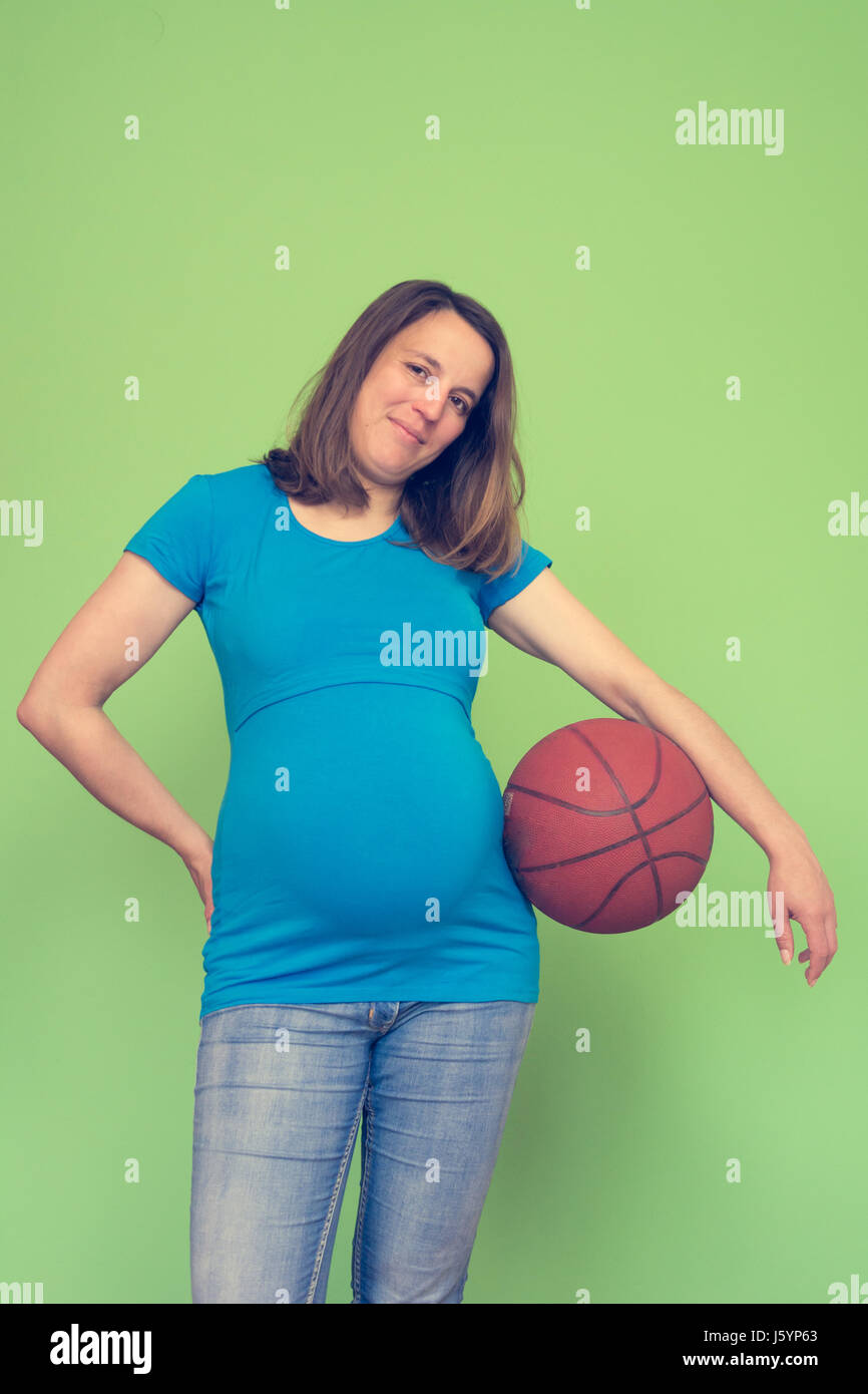 Active pregnant woman holding a basketball Stock Photo Alamy
