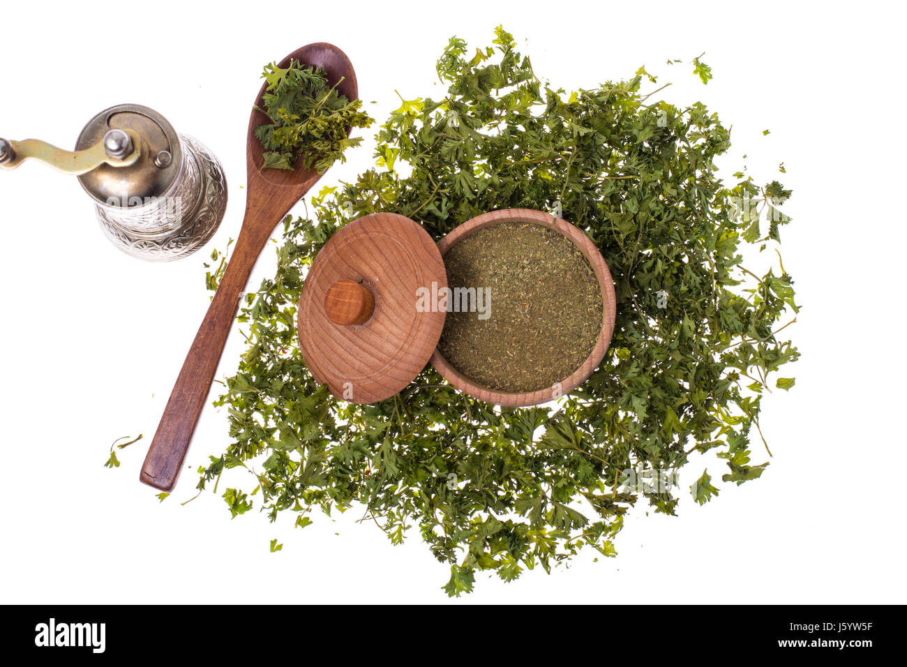 Dried and ground celery greens in a wooden jar. Studio Photo Stock Photo