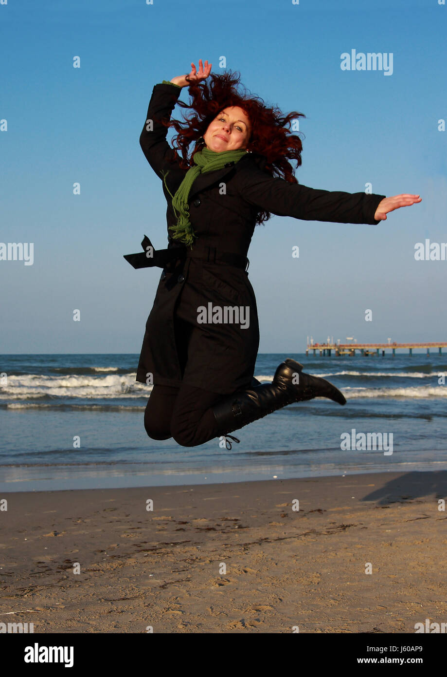 woman blue water baltic sea salt water sea ocean spring bouncing bounces hop Stock Photo