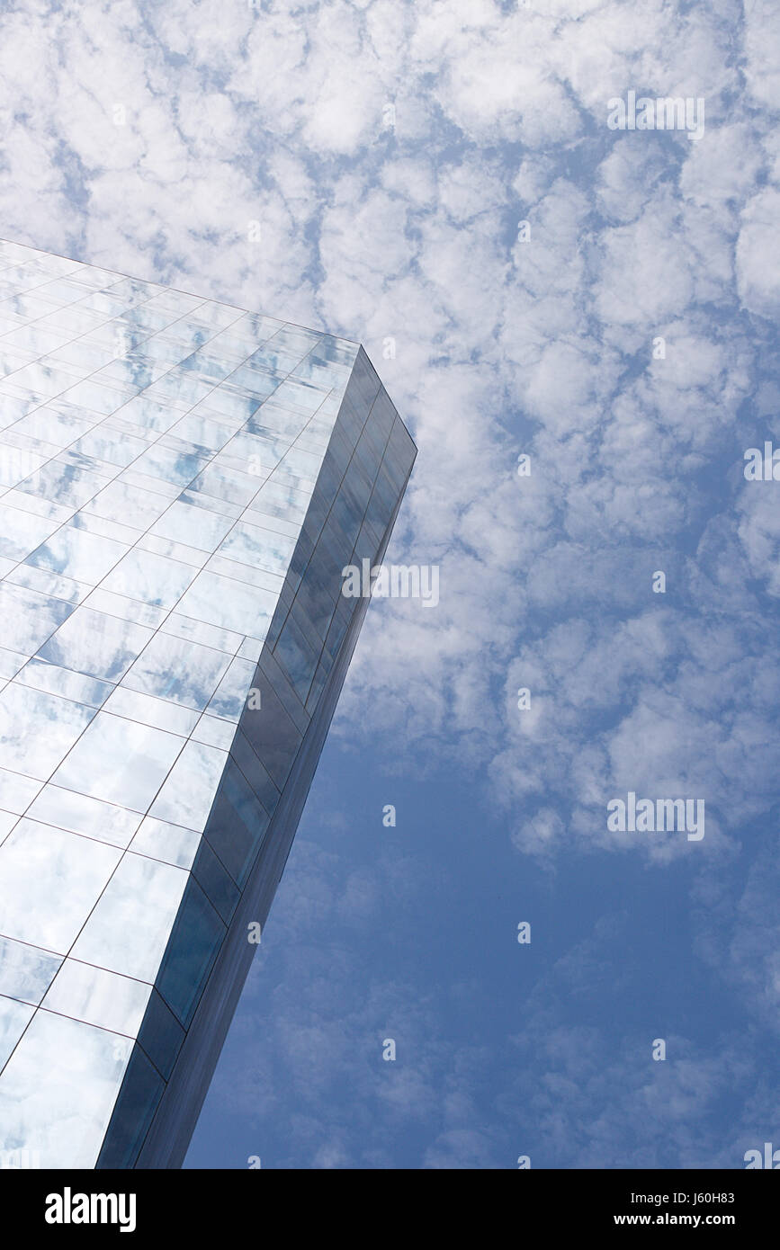 Skyscraper merging with the clouds high up in the air Stock Photo