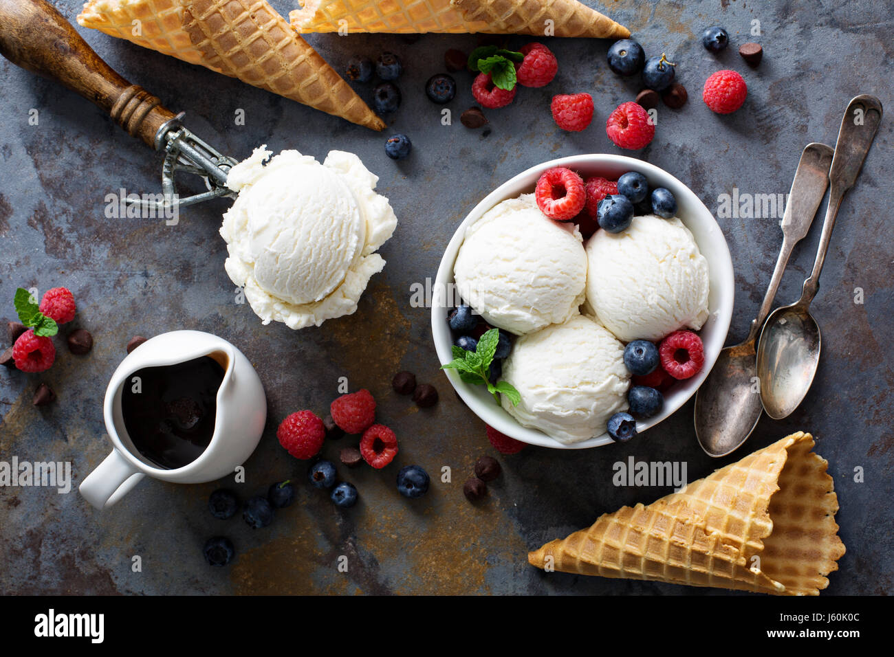 Vanilla ice cream scoops in a bowl with fresh berries Stock Photo - Alamy