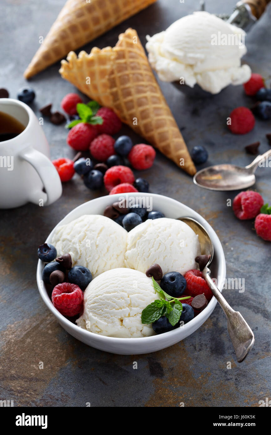 Vanilla ice cream scoops in a bowl with fresh berries Stock Photo - Alamy