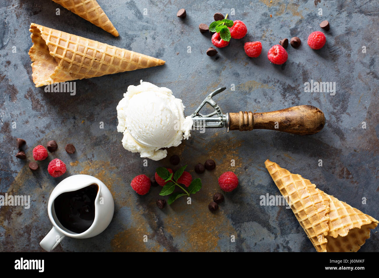 Close Up Still Life of Gourmet Double Scoop Ice Cream Sandwich with Variety  of Flavors Served on Donut with Red Berry Sauce Served on Wooden Paddle  Stock Photo - Alamy