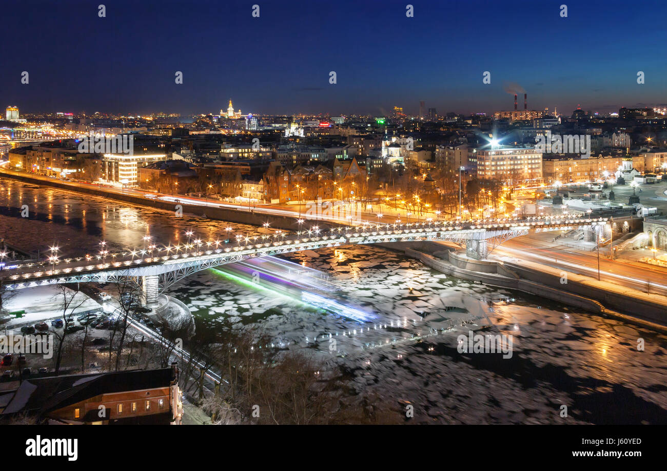 Bridge across the Moskva River with ice floes in winter. Blur from the speed boat under the bridge. Moscow, the night. Focus on bridge Stock Photo