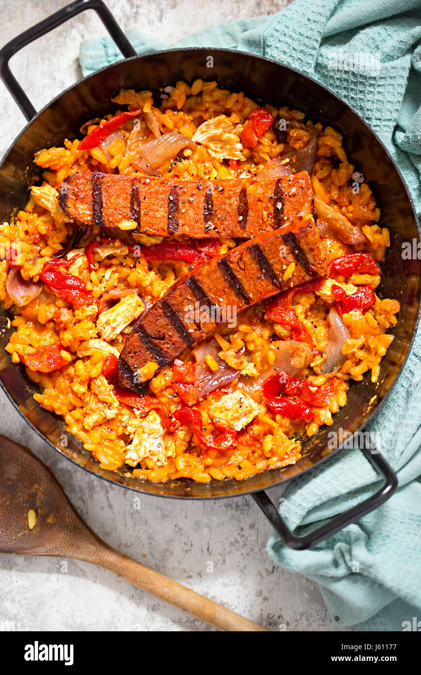 Griddled chorizo and chicken with red pepper paella Stock Photo
