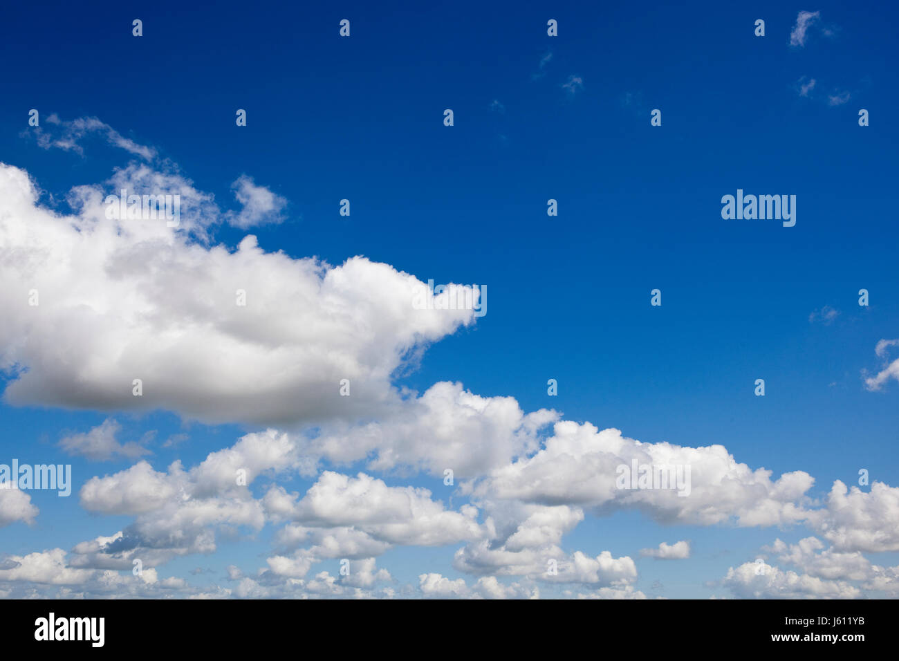 a blue sky background image with fluffy white clouds Stock Photo - Alamy