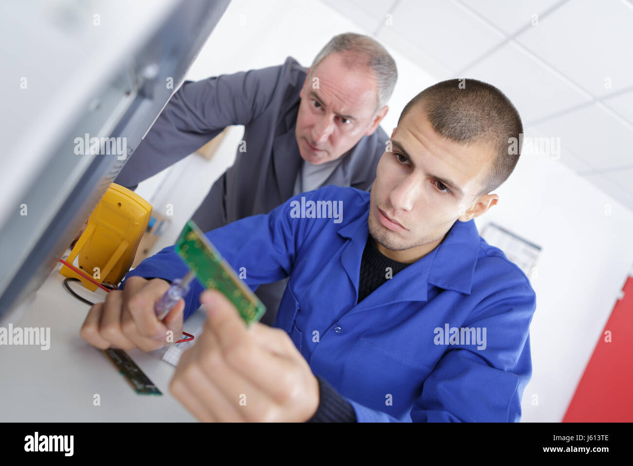 Young man testing computer component Stock Photo - Alamy