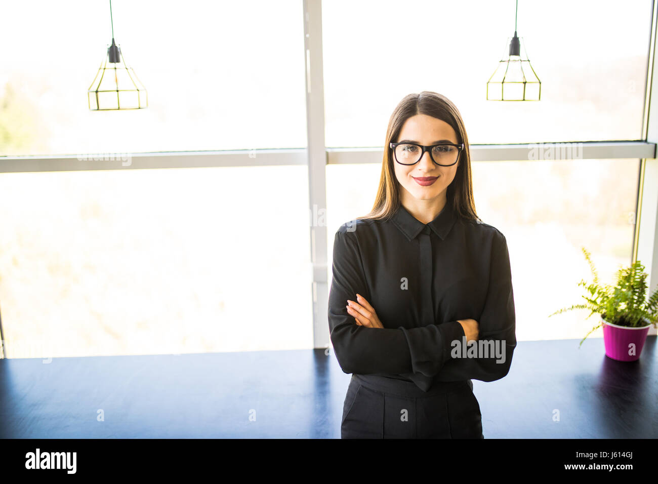 Portrait of business woman standing in office Stock Photo - Alamy