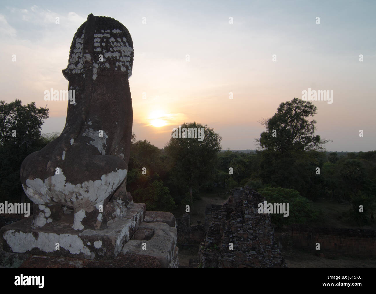 A stone statue of a lion facing the sunset at Prei Rup temple, Angkor Wat Stock Photo