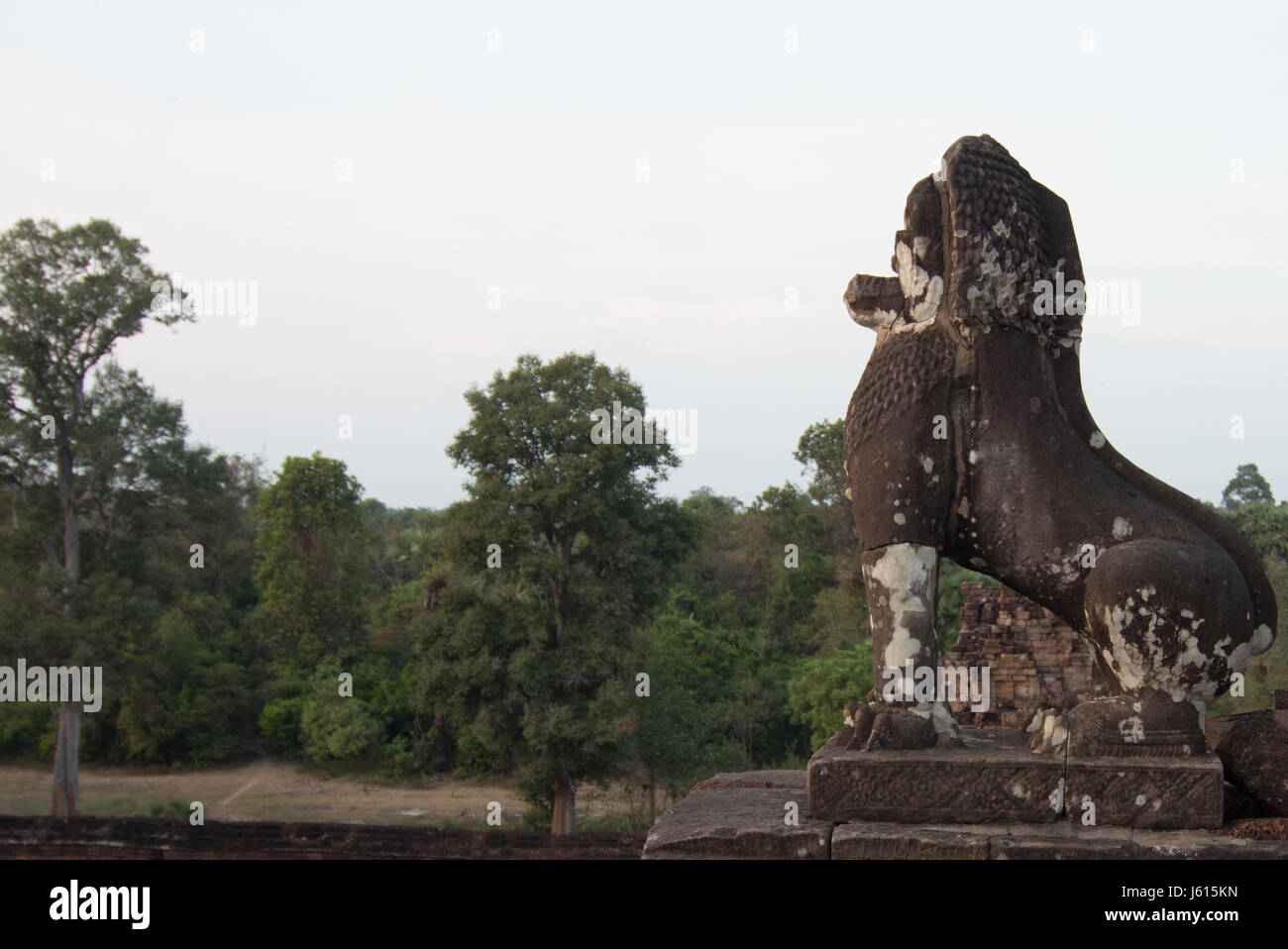 Solo stone statue of lion facing the sunset at Prei Rup temple, Angkor Wat Stock Photo