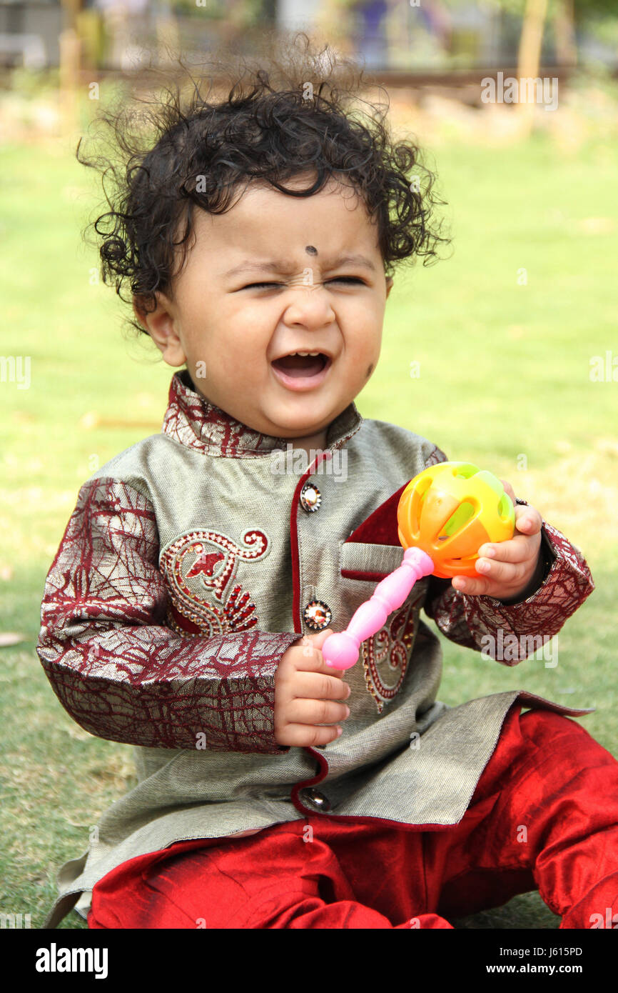 Smiling Indian Boy Baby Maracas Feather Foto de stock 95235967