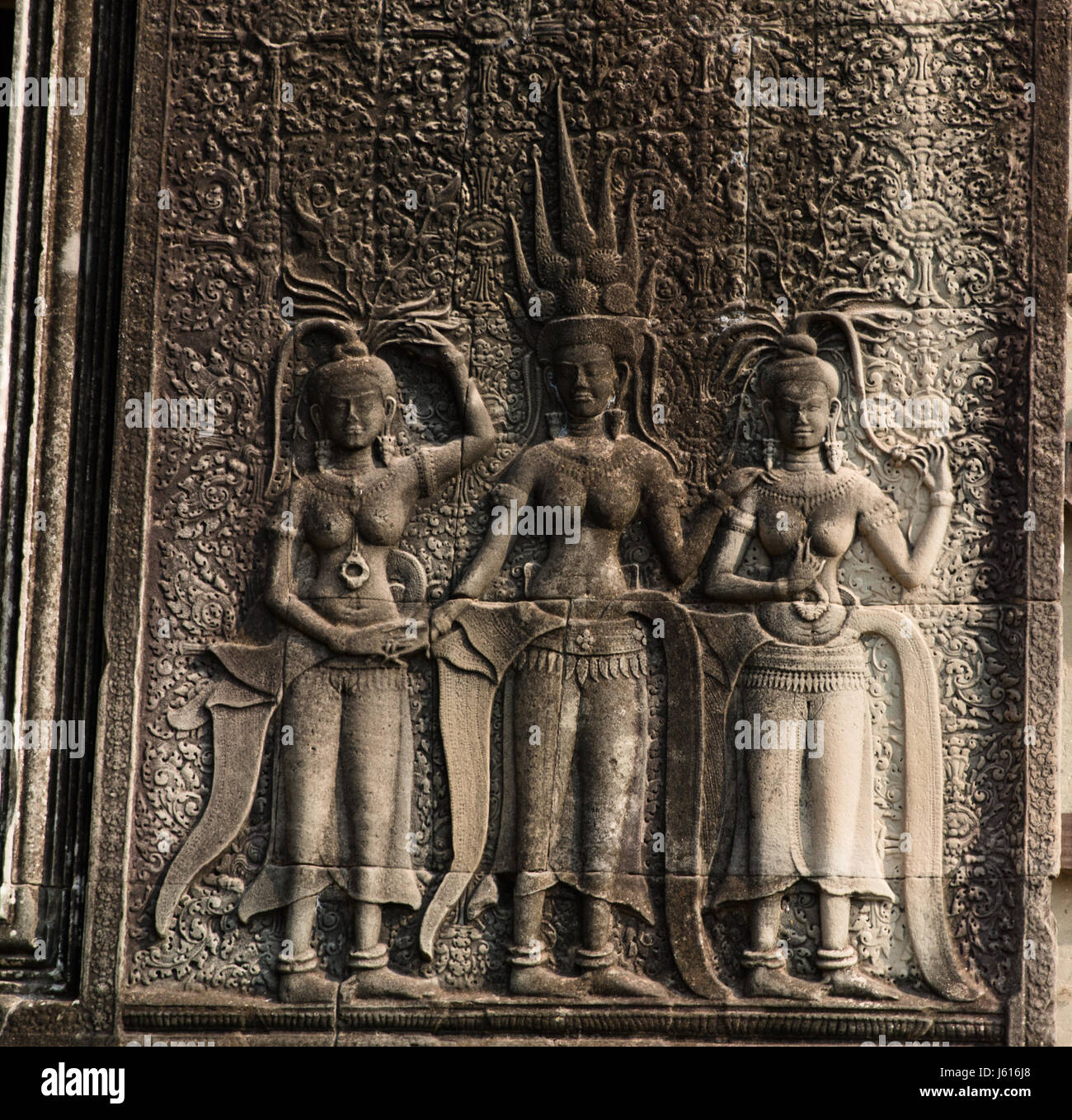 Bass relief of three apsaras at the entrance fo Angkor Wat Stock Photo
