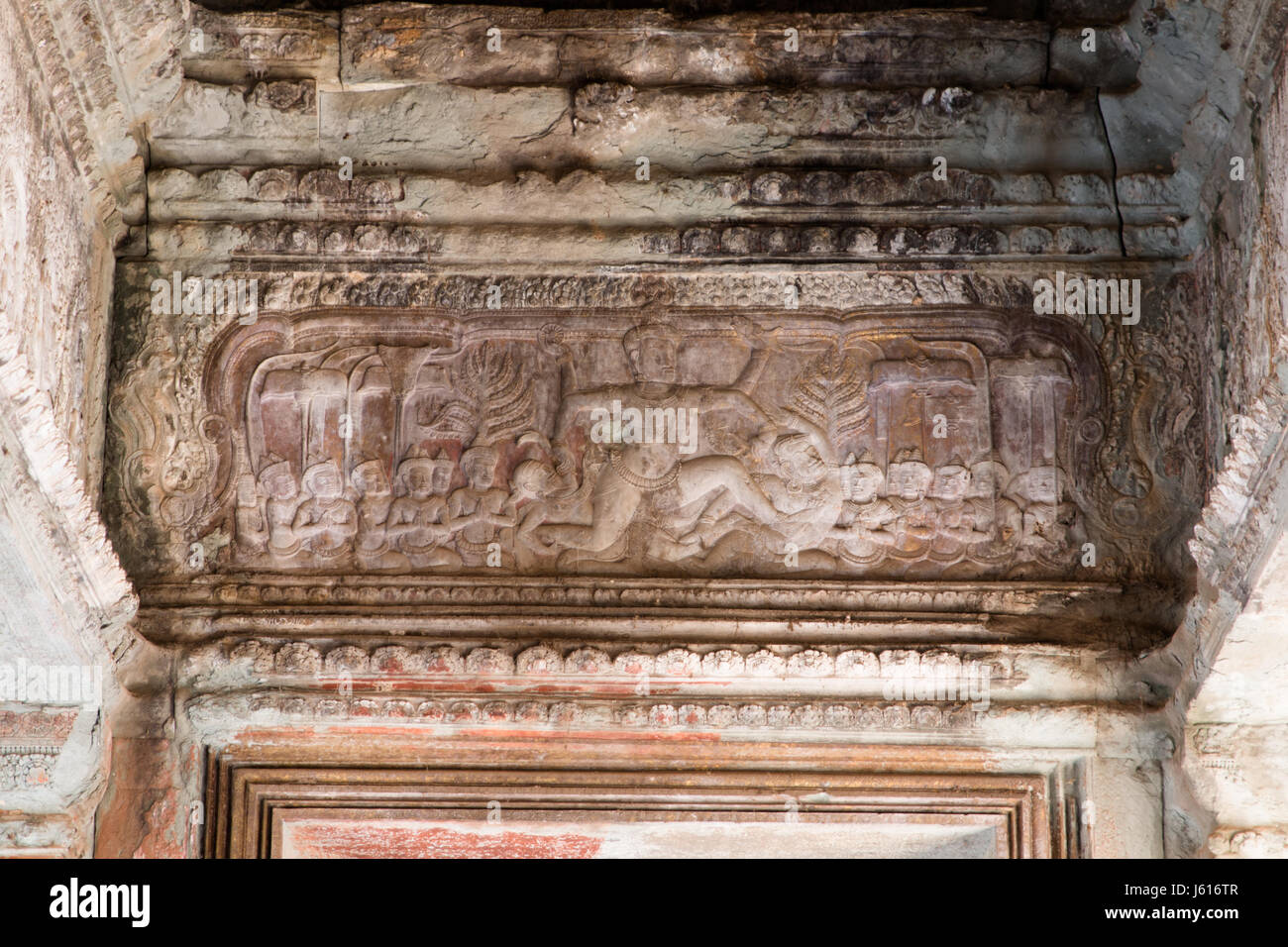 Figure of a god carved into the lintel of a doorway at Angkor Wat Stock Photo