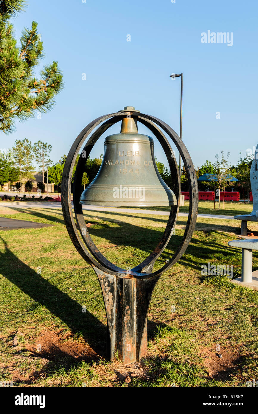 The ship bell of USS Oklahoma City on the grounds of Science Museum Oklahoma, located on Martin Luther King Blvd., Oklahoma City, Oklahoma, USA. Stock Photo