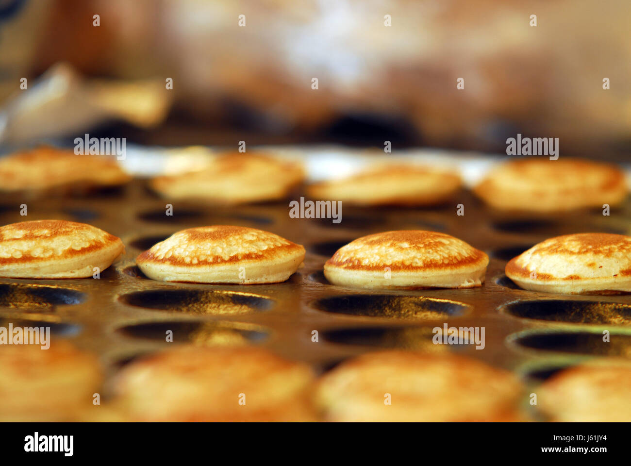 small tiny little short pastry pancakes baked fresh sheet metal shape little Stock Photo