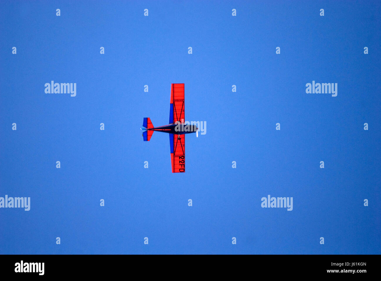 red plane on blue sky Stock Photo - Alamy