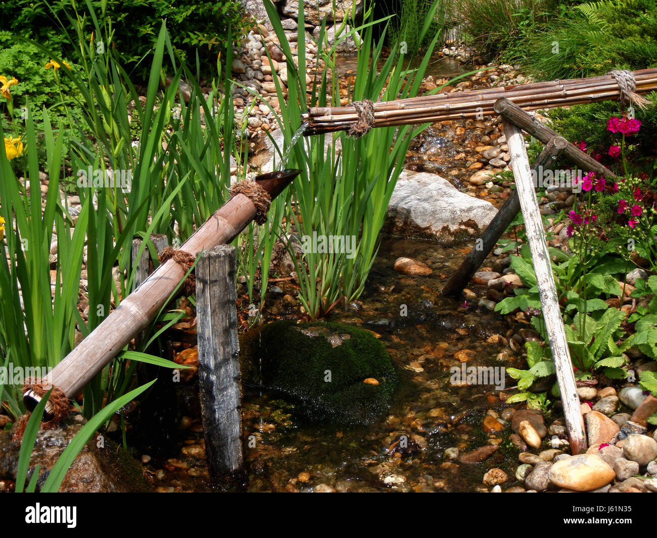 garden stream trick fountains bamboo horticulture gardens water stone trick Stock Photo